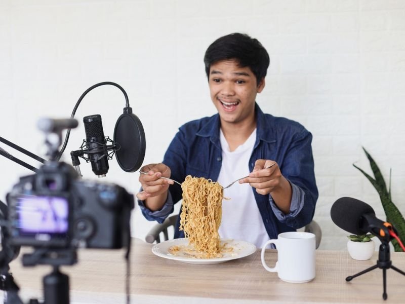 A Photo of online eating broadcasts https://showcaseschool.co/wp-content/uploads/2023/09/Mukbang-Food-Challenges-Mukbang-trend-Competes-TV-food-reviews-culinary-challenges-Cooking-Competitions-food-challenges-online-eating-broadcasts-food-consumption-food-entertainment-eating-show-food-culture-Mukbang-Food-Challenges-2d4b7bc3.jpg